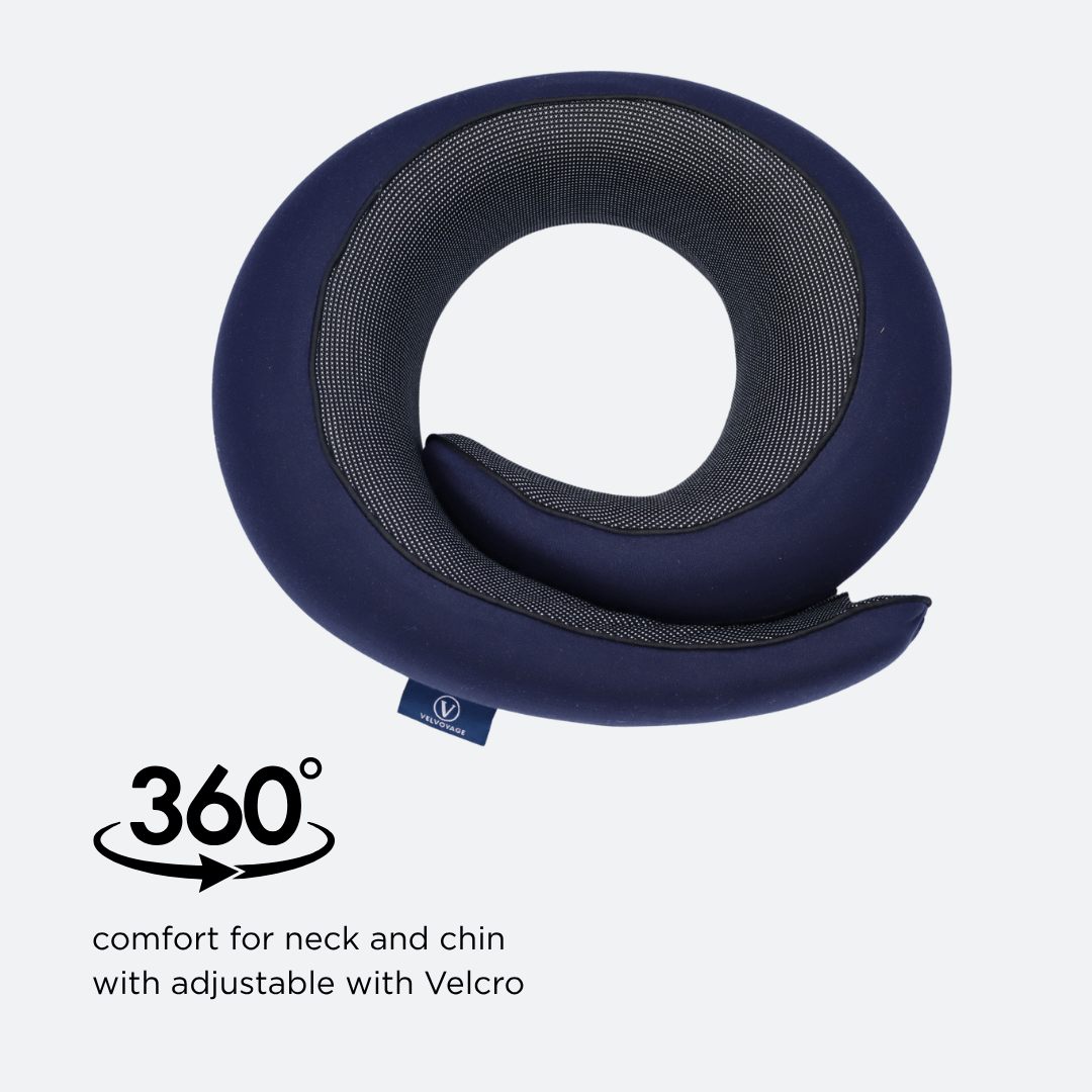 Blue neck pillow with adjustable Velcro on a light gray background